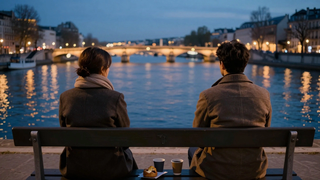 Two people sit silently on a Seine bench at twilight, sharing the calm of the city's glow.